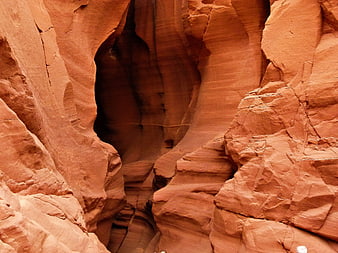 Red sandstone slot canyon walls with natural erosion patterns