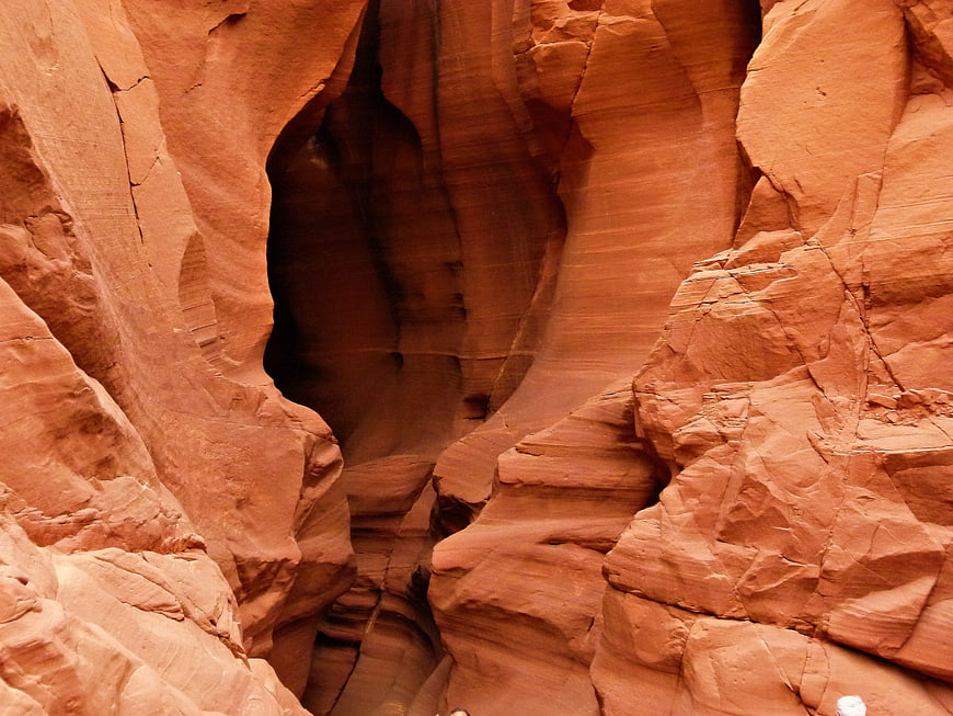 Red sandstone slot canyon walls with natural erosion patterns