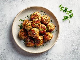 Top View of Savory Meatballs with Fresh Herbs on Plate