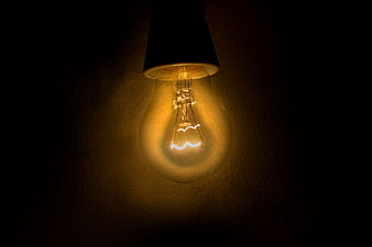 Vintage Edison Lightbulb Glowing in Dark