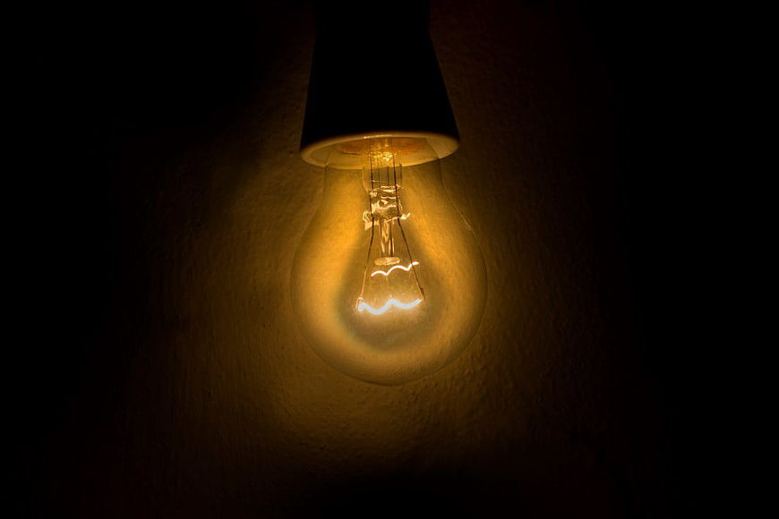 Vintage Edison Lightbulb Glowing in Dark
