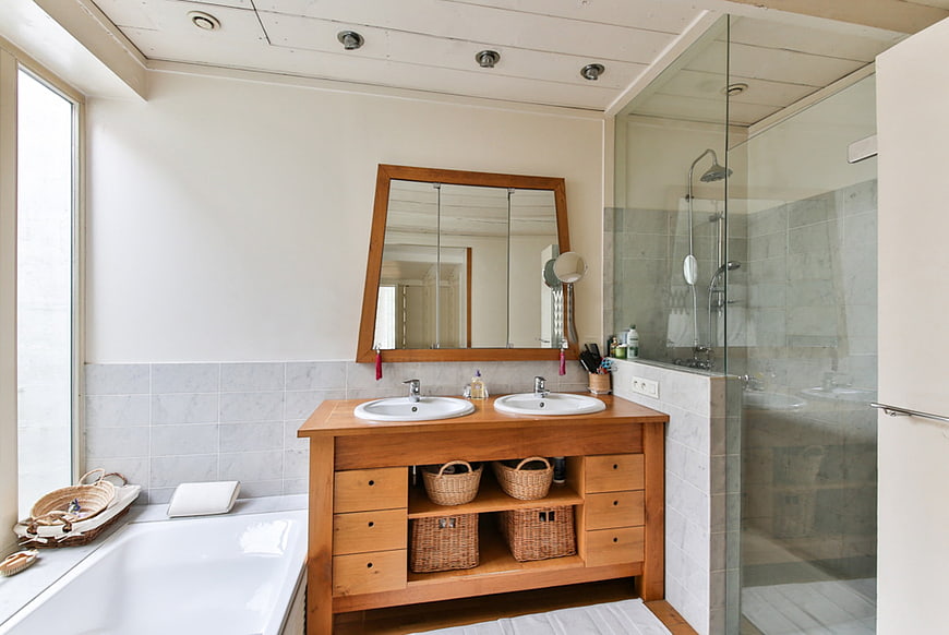 Modern bathroom with wooden double vanity and glass shower