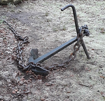 Rusty Anchor and Chain on Ground