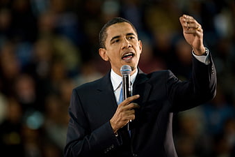 Barack Obama Speaking into Microphone at Night Rally
