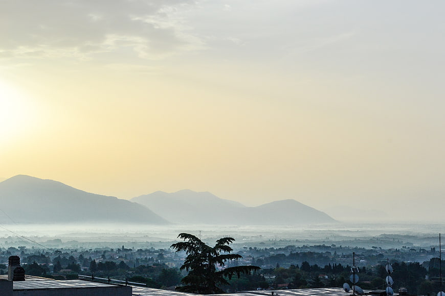 Hazy mountain landscape with city view at sunrise
