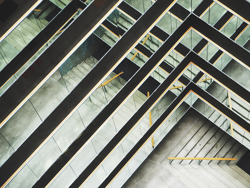 Abstract geometric modern architecture with concrete stairs and glass railings