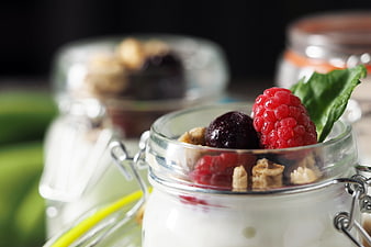 Healthy Yogurt Parfait with Raspberries and Walnuts in Glass Jar