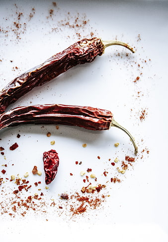 Dried chili peppers and spices on white background