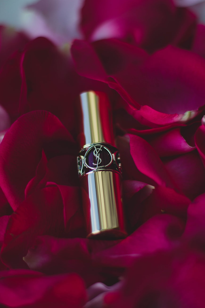 Luxury Gold Lipstick on Red Rose Petals