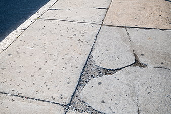 Cracked concrete sidewalk pavement texture background