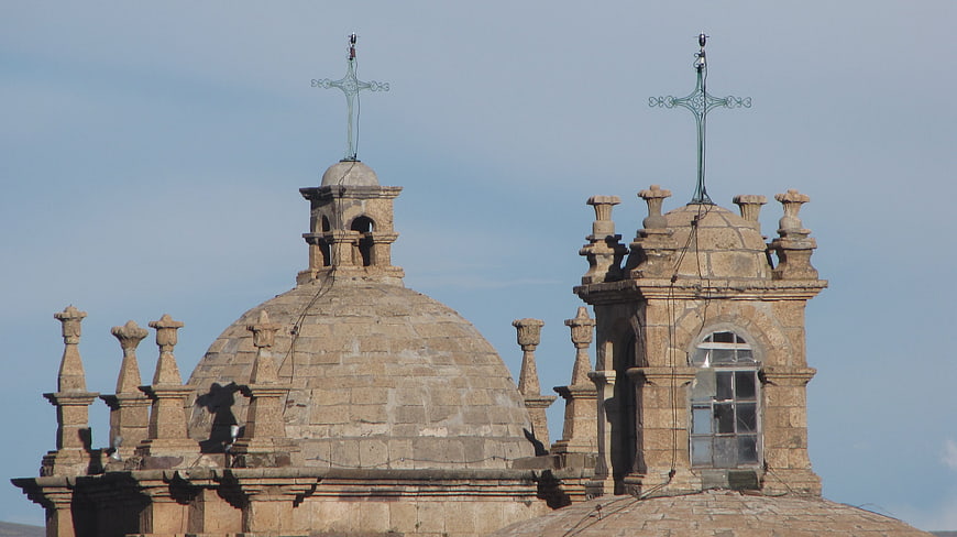 Stone church domes with crosses against blue sky