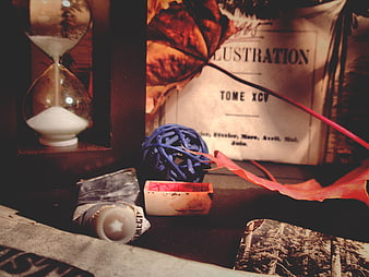 Vintage still life with hourglass, autumn leaf, and old book