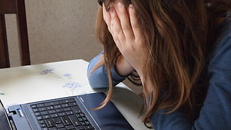 Distressed Woman Hiding Face At Laptop