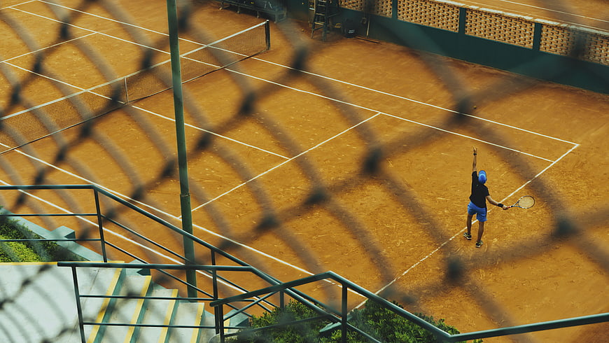 High angle view of tennis player serving on clay court