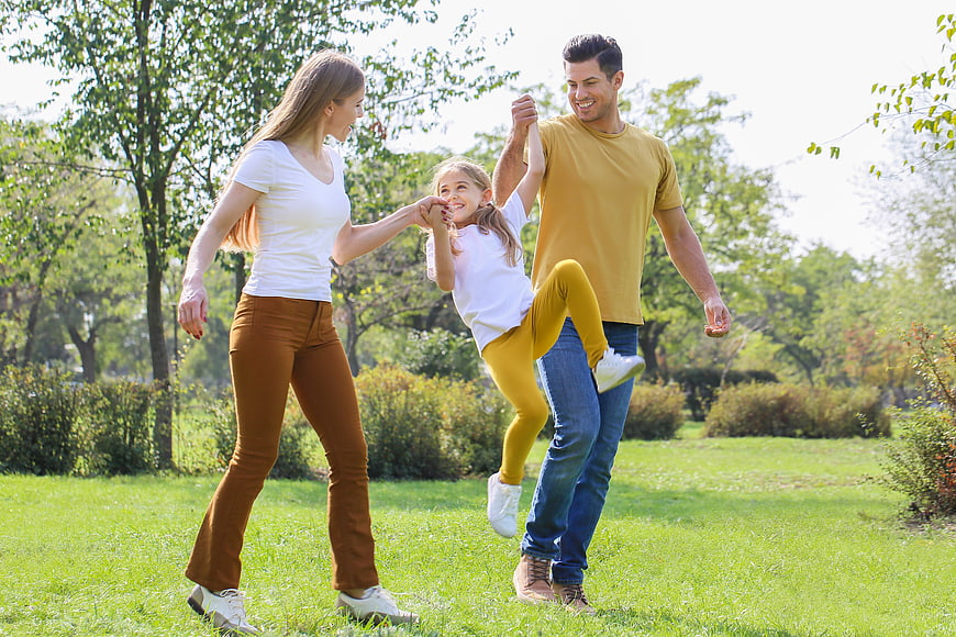 Happy family playing together in a sunny park