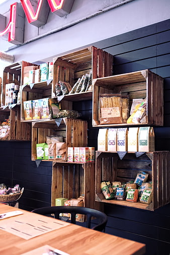 Rustic wooden crates displaying organic food products on dark wall