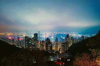 Hong Kong City Skyline At Night With Dramatic Fog And Lights