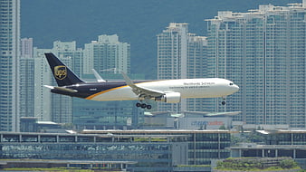 UPS Cargo Airplane Landing in Hong Kong Cityscape