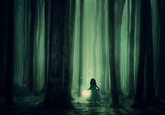 Mysterious girl with lantern in dark foggy forest