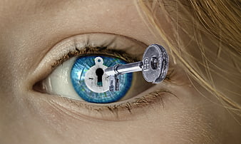 Close-up of blue eye with keyhole and key symbolizing secrets