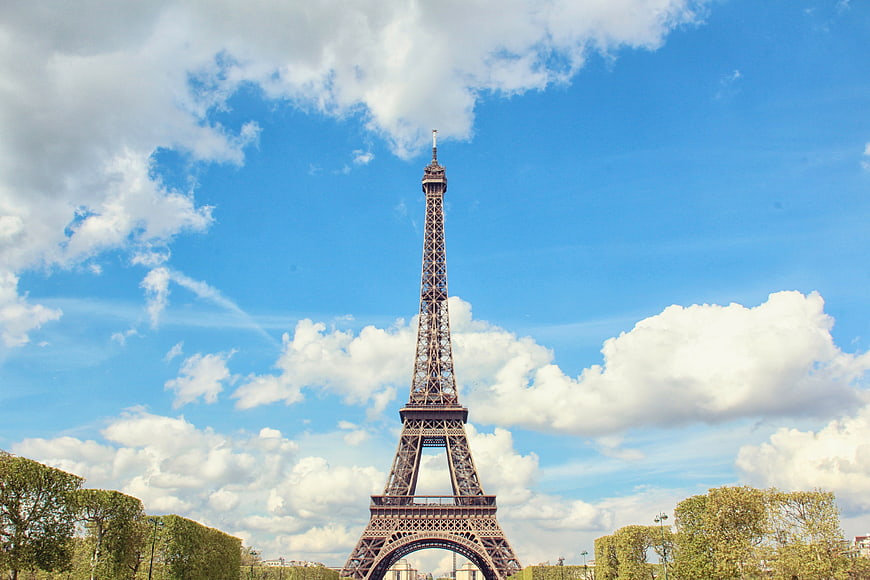 Eiffel Tower in Paris Against Blue Sky with Clouds