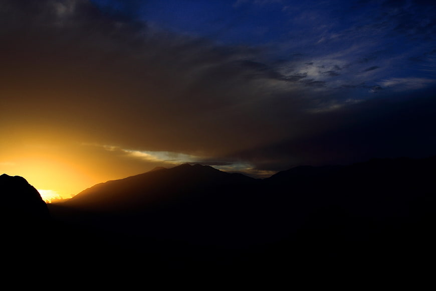 Dramatic Sunset Silhouette Over Mountain Range