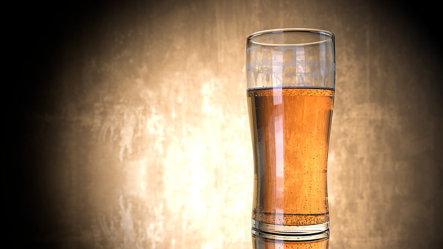 Glass of Amber Beer on Textured Background