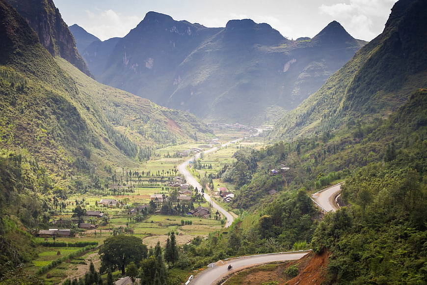 Winding Road Through Lush Green Mountain Valley Landscape