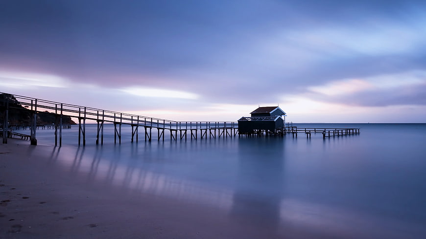 Long Exposure Wooden Pier at Twilight on Calm Ocean