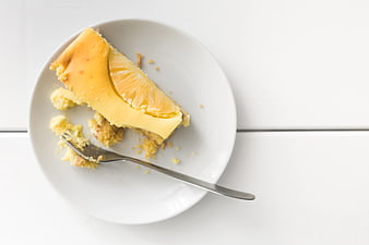 Top view of lemon cheesecake slice on white plate