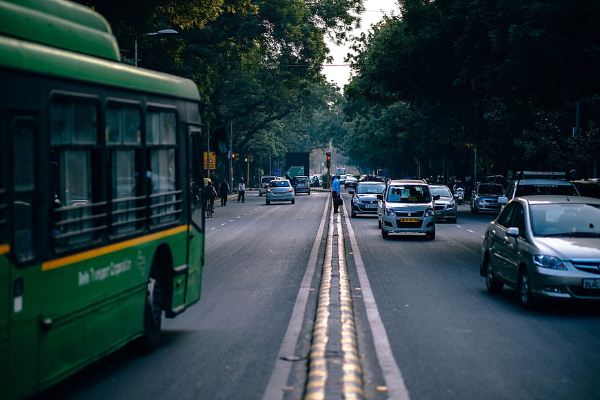Green Public Bus and Traffic on Indian City Street