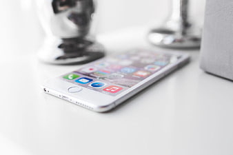 White Smartphone on Desk with Blurred Background