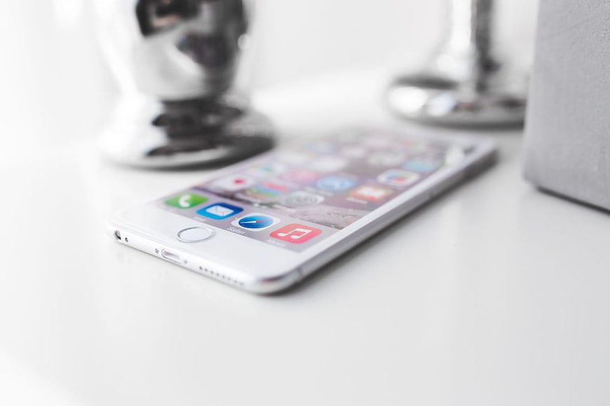 White Smartphone on Desk with Blurred Background