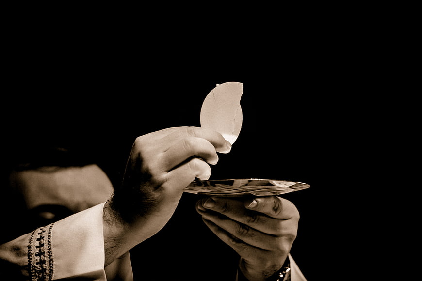 Priest elevating host during Catholic mass communion