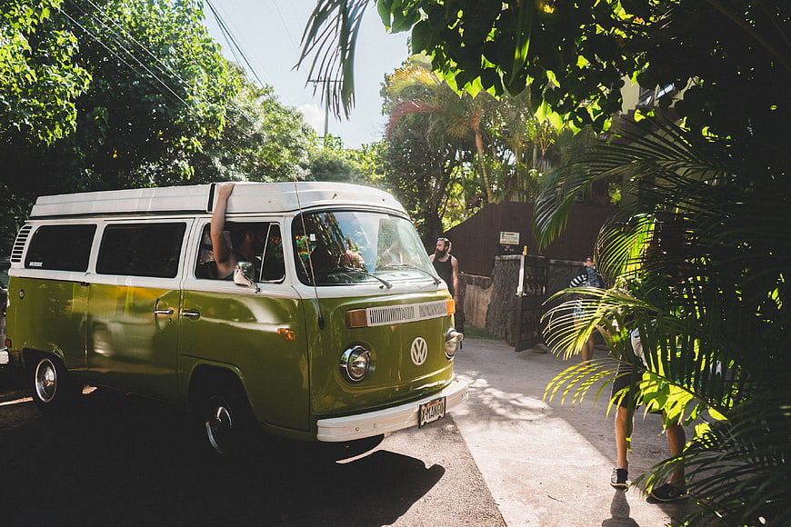 Vintage Green VW Bus Parked on Tropical Street