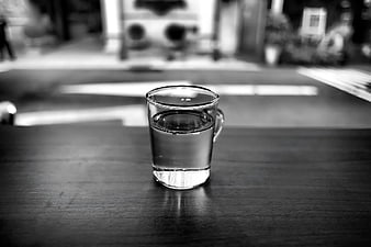 Black and white glass of water on wooden table