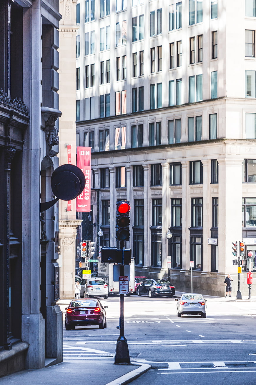 Urban street scene with red traffic light and city buildings