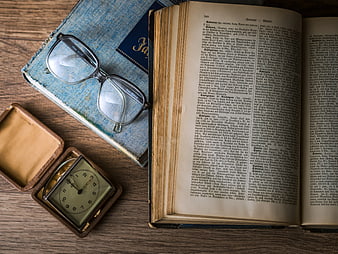 Vintage Books, Glasses, and Pocket Watch on Wooden Table