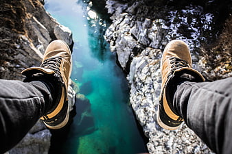 POV Hiking Boots Over Turquoise River Canyon