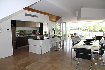 Modern luxury kitchen and dining room with waterfront view