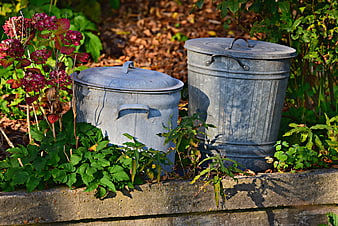 Vintage Galvanized Metal Trash Cans In Garden