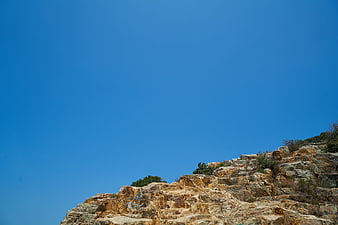 Rugged Rocky Cliff Against Clear Blue Sky