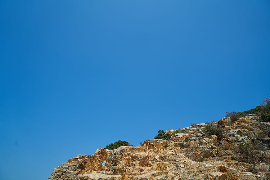 Rugged Rocky Cliff Against Clear Blue Sky
