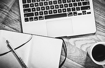 Black and White Workspace with Laptop, Notebook, and Coffee