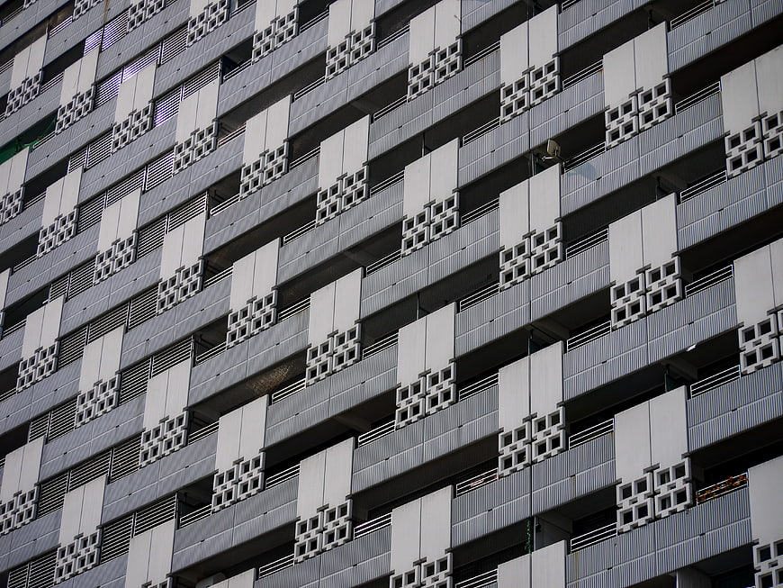 Modern Concrete Building Facade with Geometric Balcony Patterns