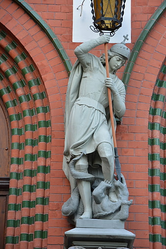 St. George Statue on Red Brick Church Wall