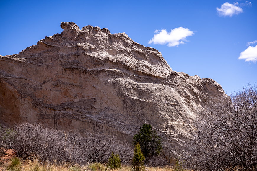 Rugged Sandstone Rock Formation Under Blue Sky