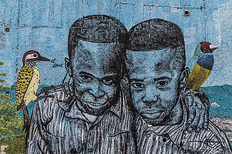 Street Art Mural of Two Boys with Birds on Blue Wall