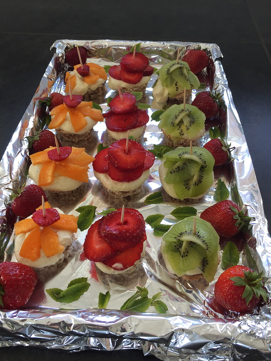 Fruit topped mini desserts on aluminum foil tray