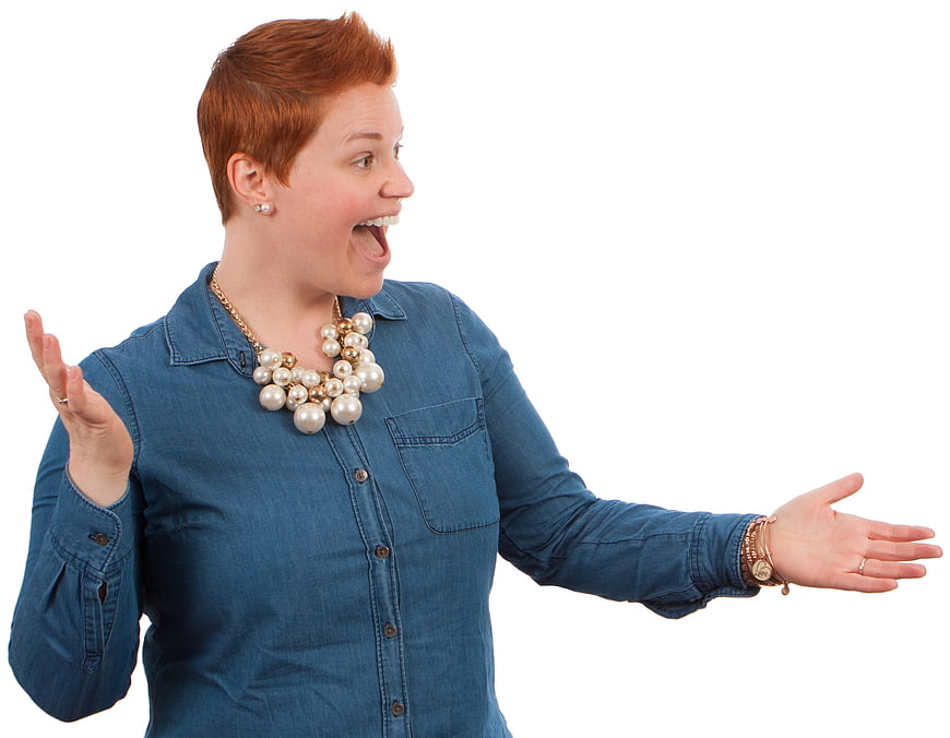 Excited woman with short red hair gesturing on white background